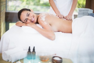 Young woman smiling while receiving spa 