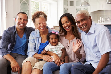 Grandparents and parents with a baby girl on mum’s knee