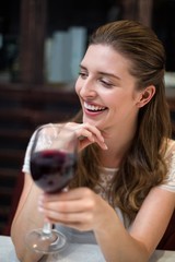 Cheerful woman holding wine glass