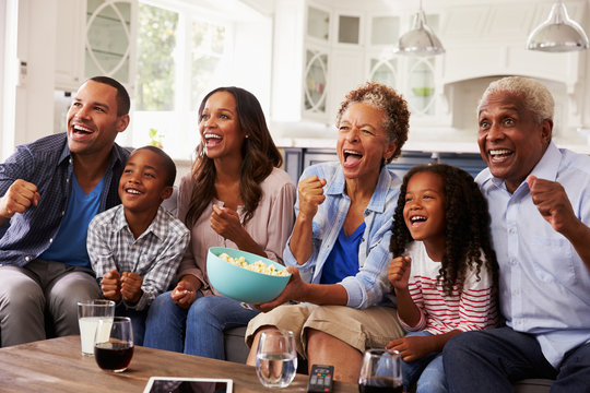 Multi Generation Black Family Watching Sport On TV At Home