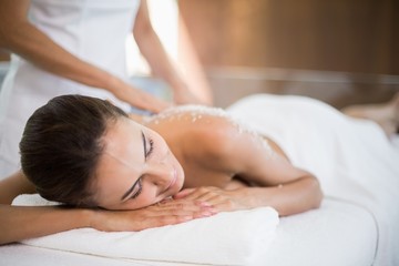 Obraz na płótnie Canvas Woman receiving spa treatment from female masseur