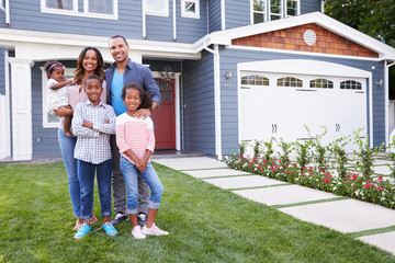 Happy black family standing outside their house - Powered by Adobe