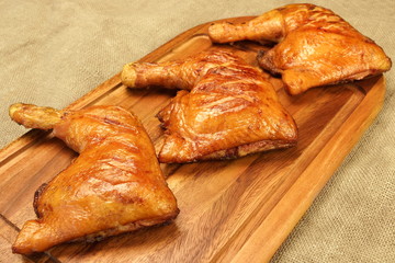 Three Grilled BBQ Chicken Leg Quarter On Wood Board