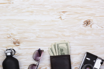 gentlemanly set:  sunglasses, perfume, wallet, money,camera on wooden background