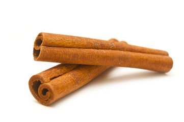 Two sticks of cinnamon on a white background