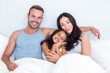 Happy family in their bedroom