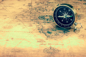 Fototapeta na wymiar Magnetic Compass On The Old Map, Closeup