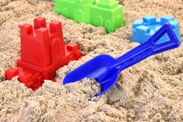 Colored Plastic Shovel And Mold In  Sand On The Beach