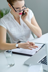 Beautiful woman with glasses in office 