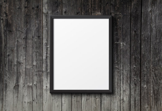 Blank black picture frame on the dark wood texture
