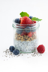 Breakfast in a glass jar, chia with berries and oat flakes 