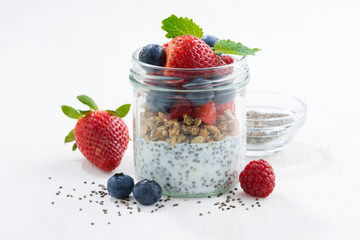 Breakfast in a glass jar, chia with berries and oat flakes 