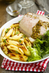 Roasted pork with potato, green salad and mustard