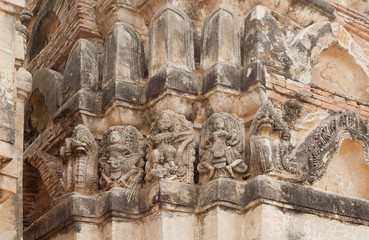 Stone relief handcraft on wall of 12th century temple inside Sukhothai historical park