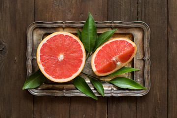 Fresh grapefruit with leaves  on a tray