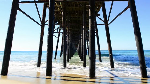 Waves under the fishing pier, in Imperial Beach, California.