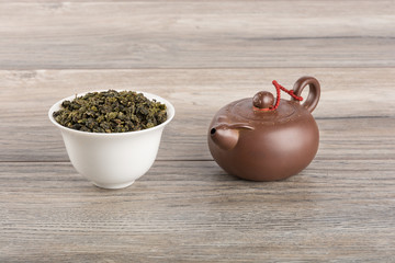 Green tea and teapot on wooden table