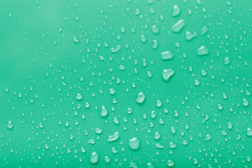 Dops of water on a color background. Green. Toned
