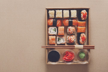 Set of sushi rolls at carton texture background 