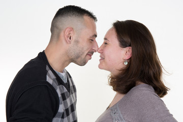 Beautiful affectionate couple smiling - isolated over a white background