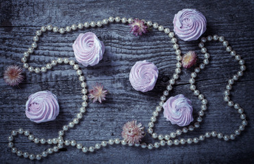 Fresh pink homemade zephyr - marshmallow on old wooden table. To