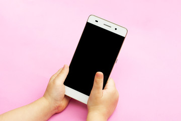 smart phone in the hands of a child