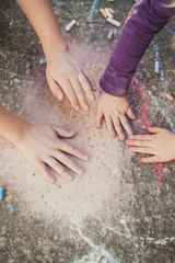 Children playing with colored chalks