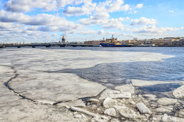 A view of moving ice on the Neva river at  Leutenant Schmidt Embankment with St.Isaac cathedral on the background