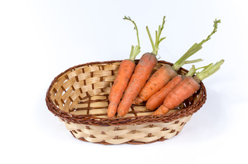 fresh carrots in a basket isolated on white background
