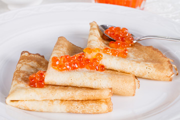 Russian pancakes with red salmon caviar