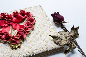Love diary and Roses wilt on white canvas background