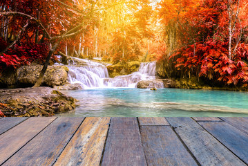 Fototapeta premium Vintage style wooden floor perspective with beautiful autumn waterfall.