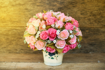 Plastic flowers with wooden background in vintage picture style, home interior equipment, Flowers set on wooden background. Hand made.