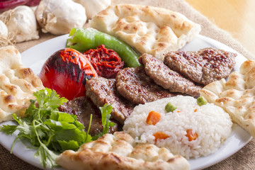 Delicious Turkish Traditional Kebab Kofte with pilaf on white plate (meatballs)