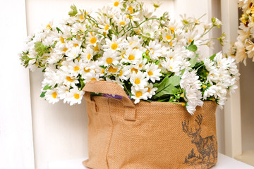 White flowers bouquet in sack bag 