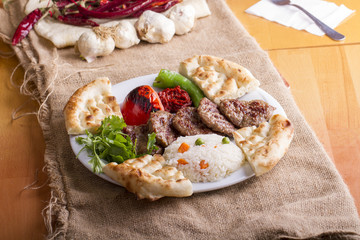 Delicious Turkish Traditional Kebab Kofte with pilaf on white plate (meatballs)