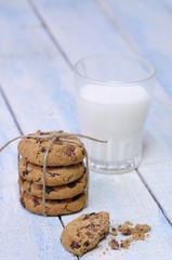 Close-up of glass of milk and stack of cookies