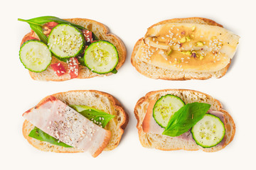 Different tartines on the white background top view
