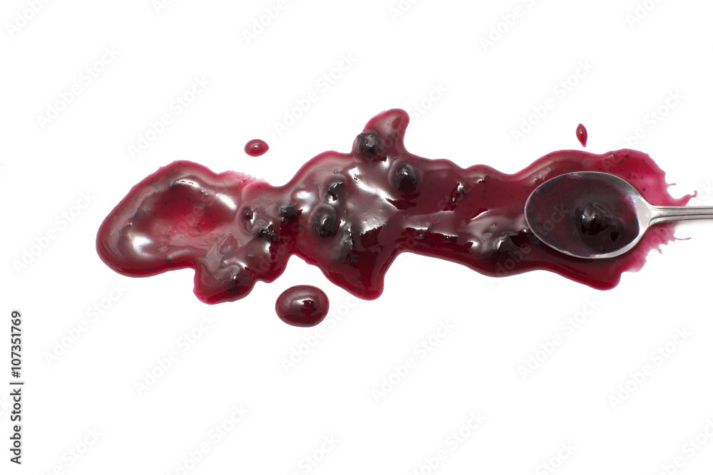 Wall mural splashes, droplets and spilled blueberry jam with a spoon. blot the huckleberry jam teaspoon and dip