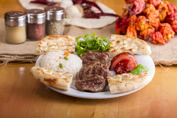 Delicious Turkish Traditional Kebab Kofte with pilaf on white plate (meatballs)