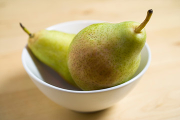 Two pears in a white porcelain bowl