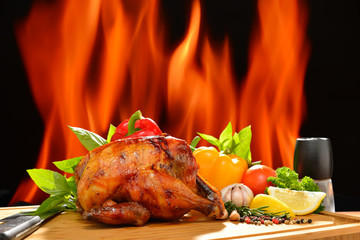 Roast chicken and various vegetables on a chopping wood
