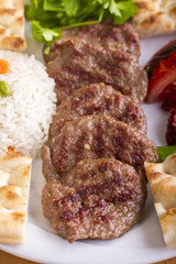 Delicious Turkish Traditional Kebab Kofte with pilaf on white plate (meatballs)