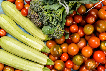 Fototapeta na wymiar Orchard Country Vegetables. / Orchard country vegetables: zucchini, cabbage and red tomatoes. light blue background.