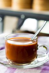hot milk tea in glass cup on a table