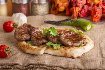 Delicious Turkish Traditional Kebab Kofte with pilaf on white plate (meatballs)