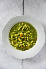 Spinach soup with noodles.
