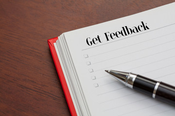 Conceptual,notebook on a wooden table. open diary and pen to rec