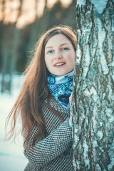 Fototapeta premium Young woman walking stands of birch