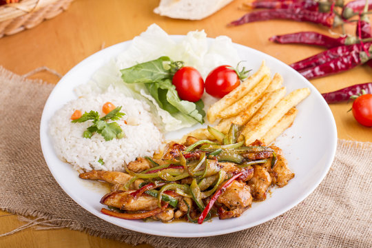 original fajita sizzling smoking Chicken breast with vegetables and sauce decorated with basil leaves